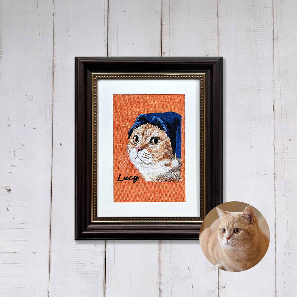 Dark-framed custom pet memorial embroidery displayed on a wall as a remembrance keepsake