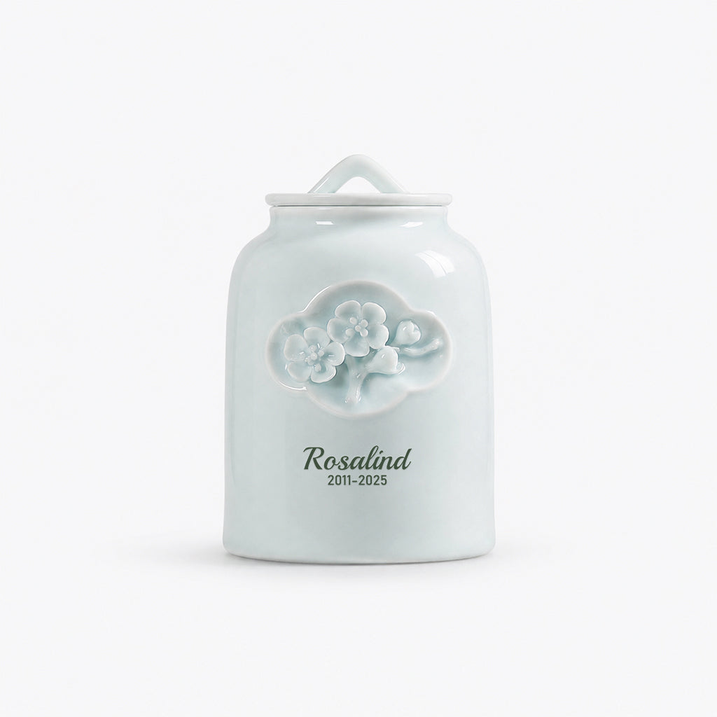 Top-down view of celadon floral relief urn showing lid detail and ceramic glaze finish