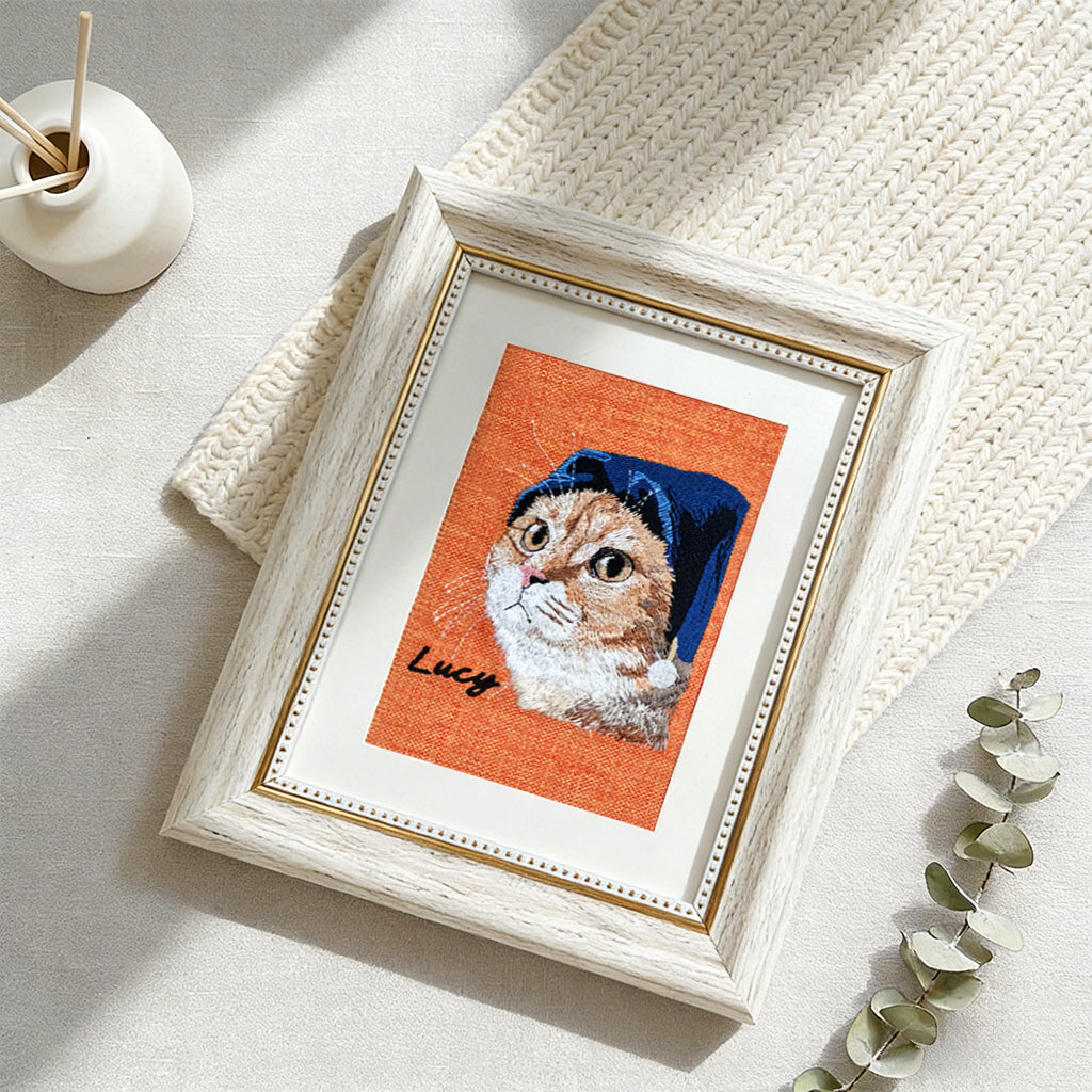 Close-up of stitched pet portrait embroidery showing fine thread detail on natural linen fabric