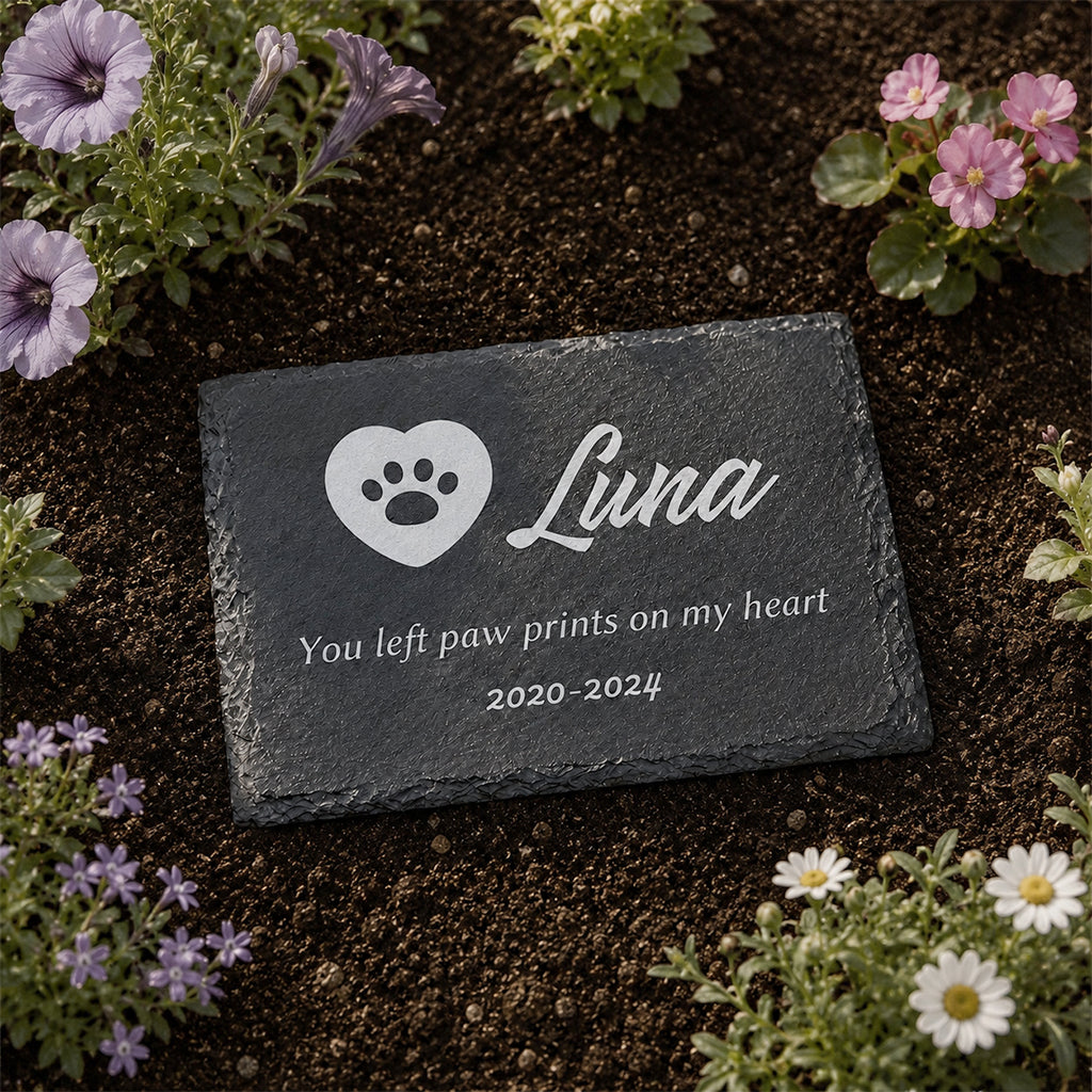 Personalized pet memorial slate plaque with engraved pet name and remembrance message in a garden