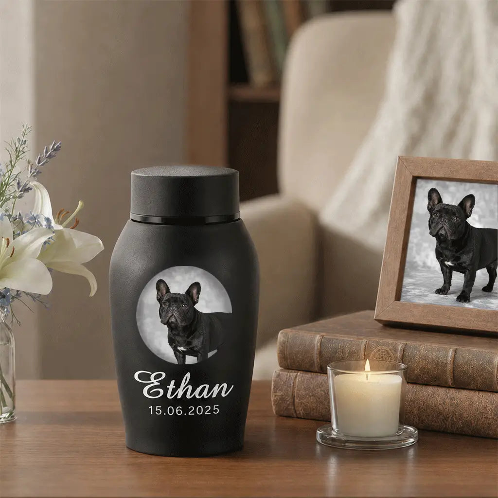 Close-up of custom dog urn showing the pet's photo, name and memorial dates on a matte black finish