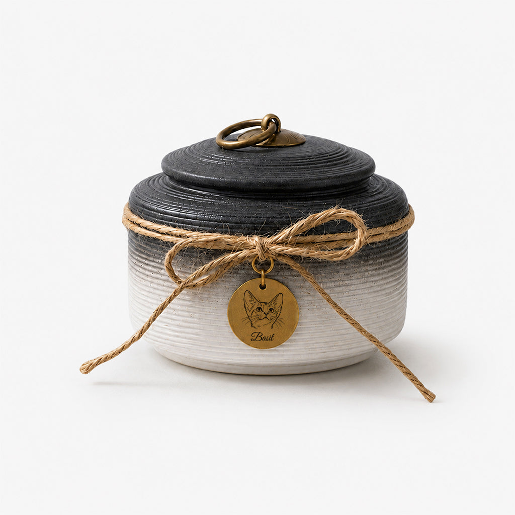 Detail of textured ceramic surface and jute bow on a personalized cat memorial urn