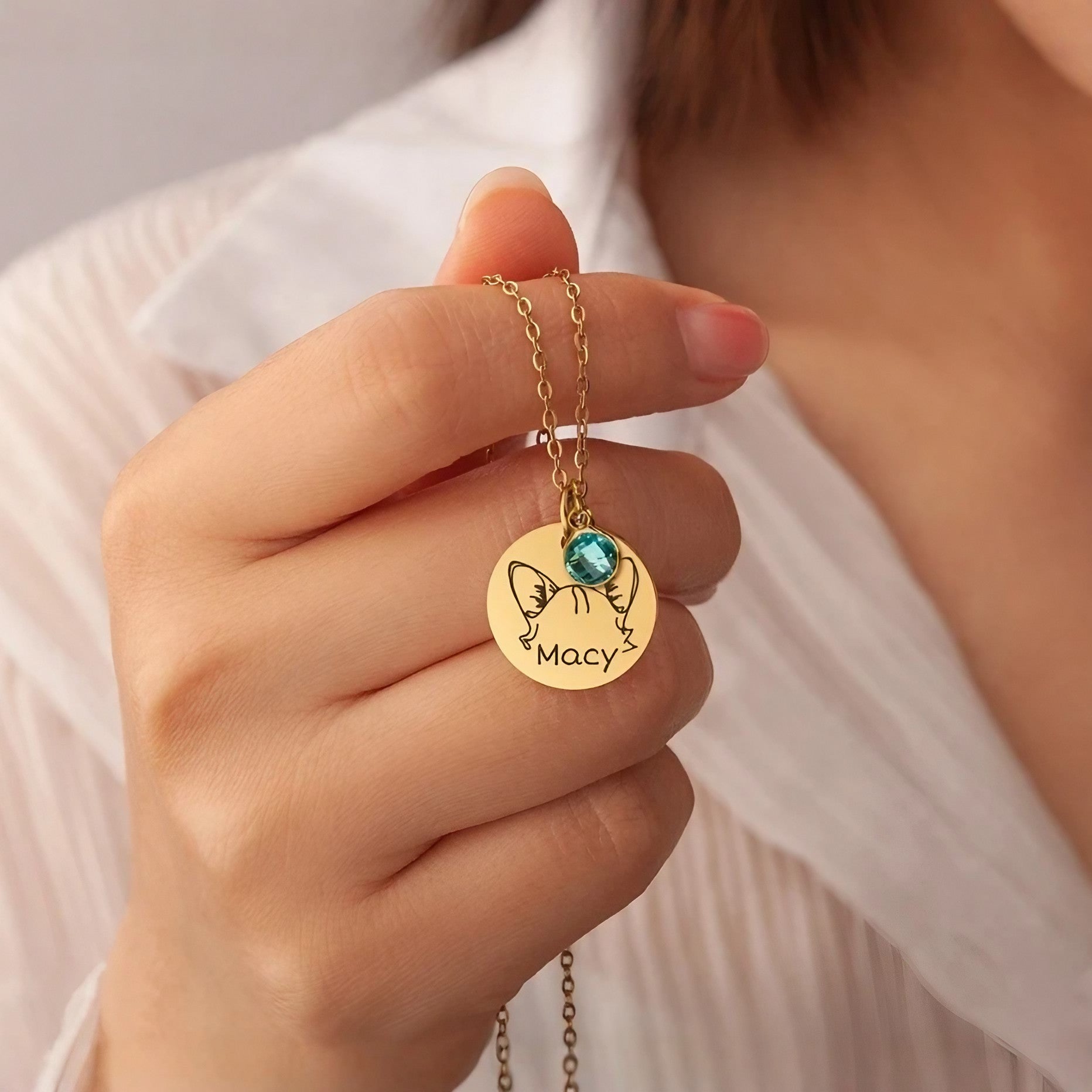 Person wearing a personalized pet birthstone necklace as a keepsake gift for pet moms