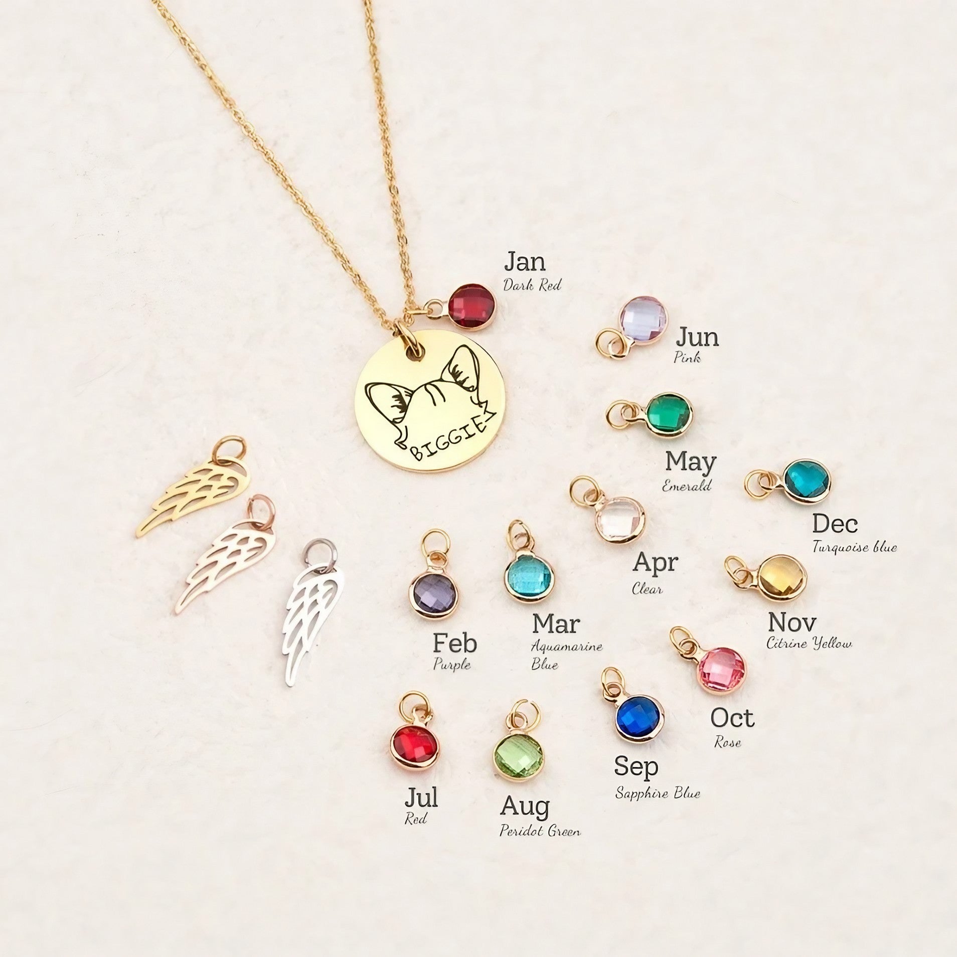 Close-up of engraved pet portrait and birthstone charm on a delicate gold pendant necklace