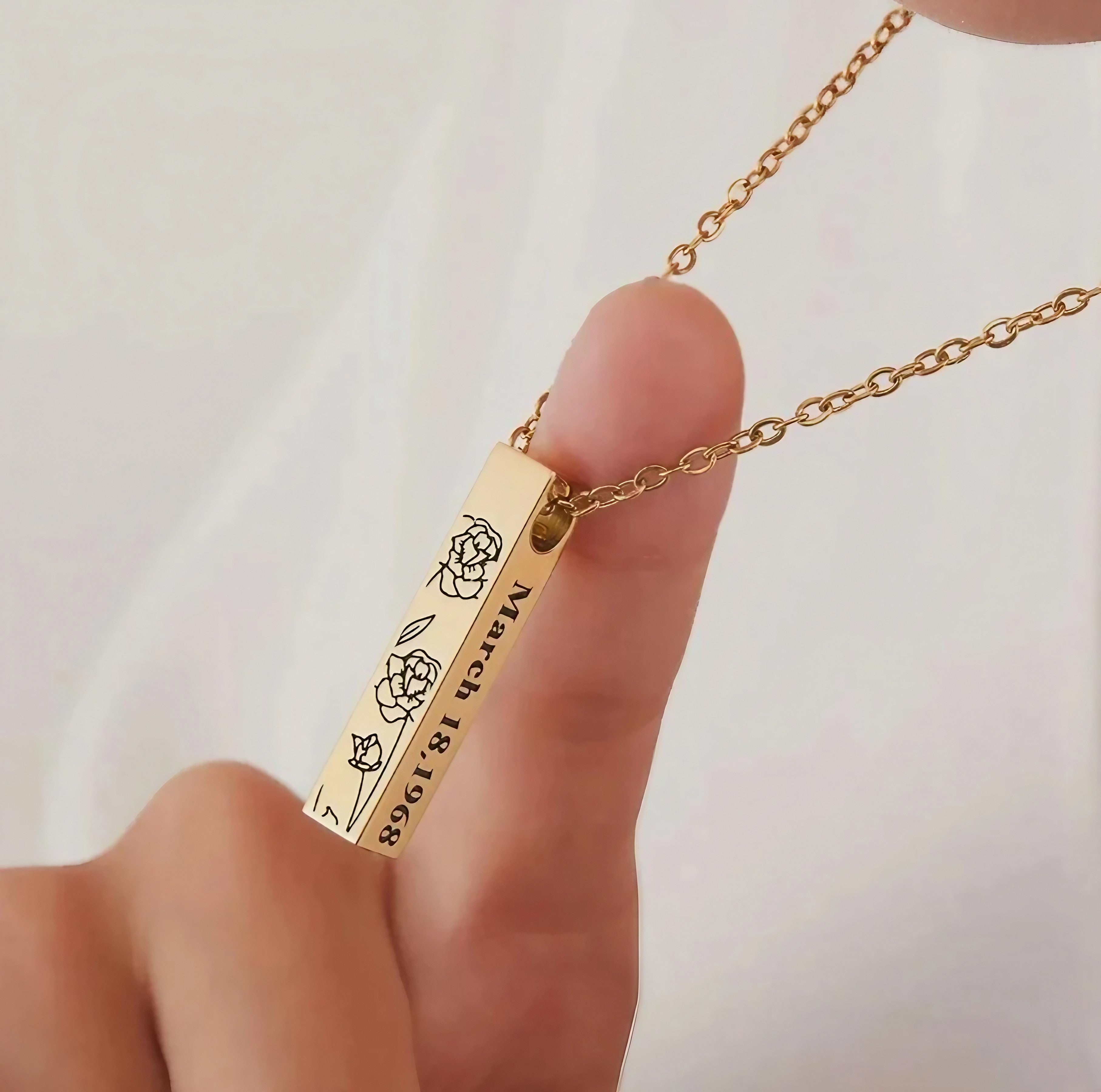Person wearing a personalized pet memorial bar necklace as a pet loss keepsake gift