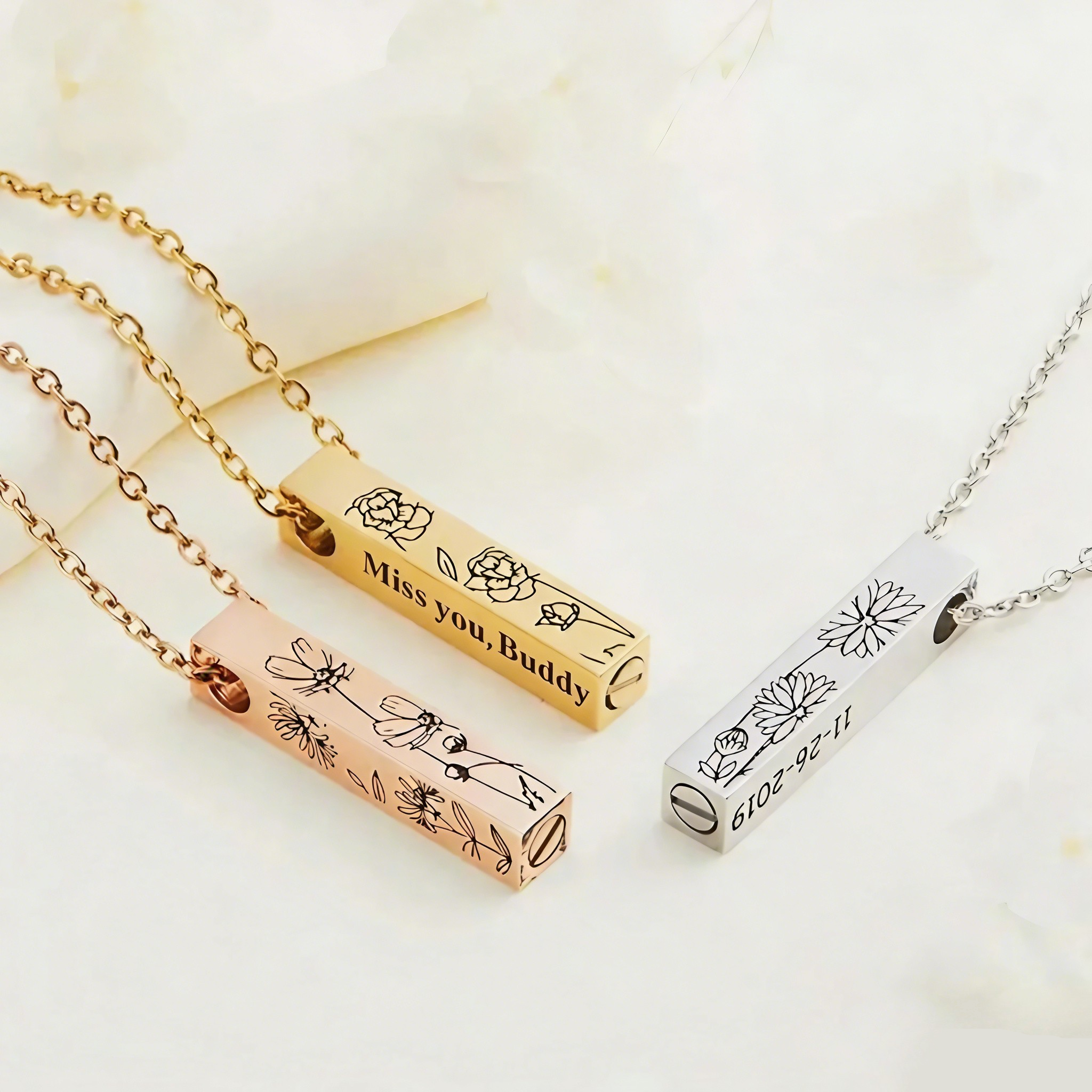 Close-up of engraved pet name and date on a slim bar pendant memorial necklace