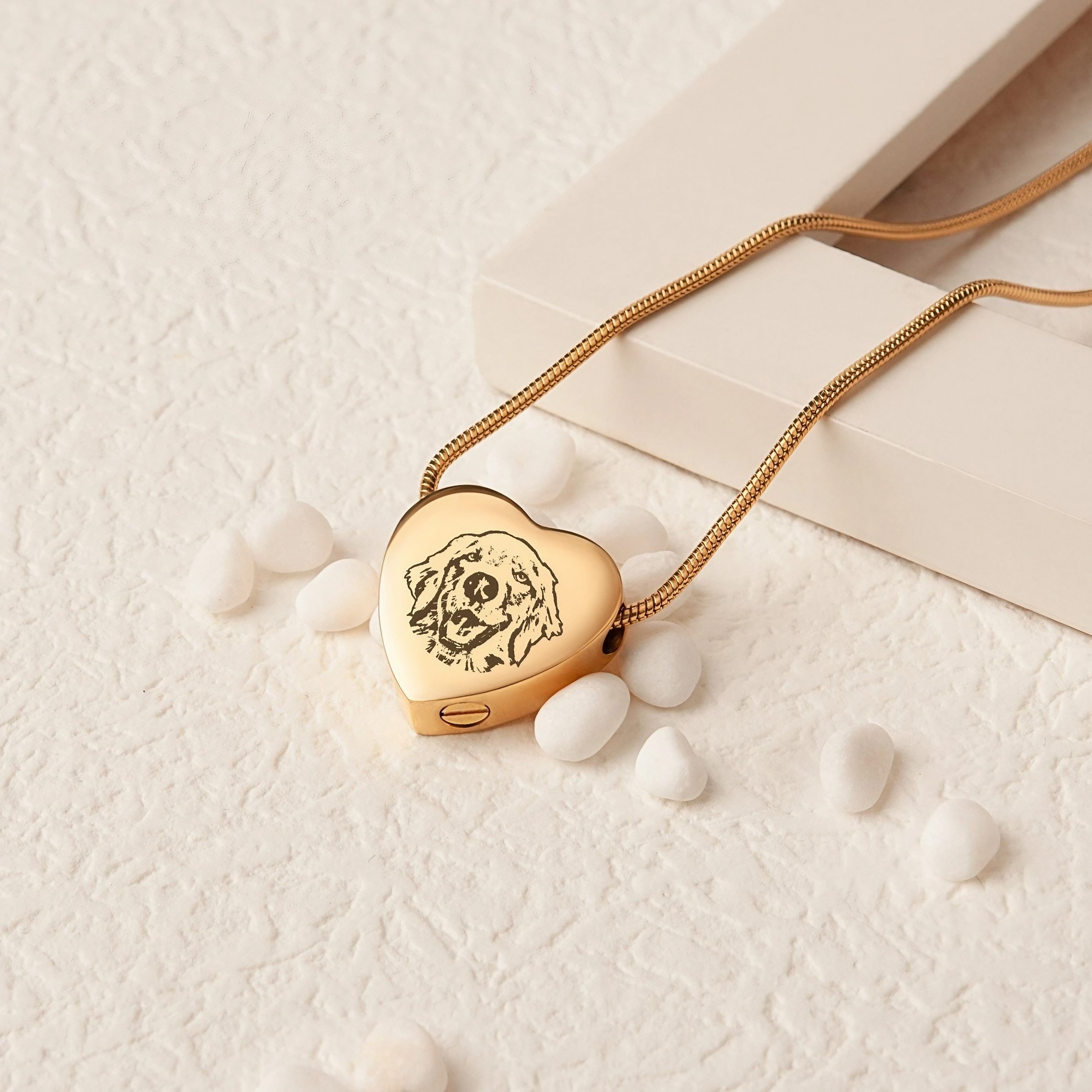 Close-up of engraved pet portrait on a heart-shaped memorial necklace pendant