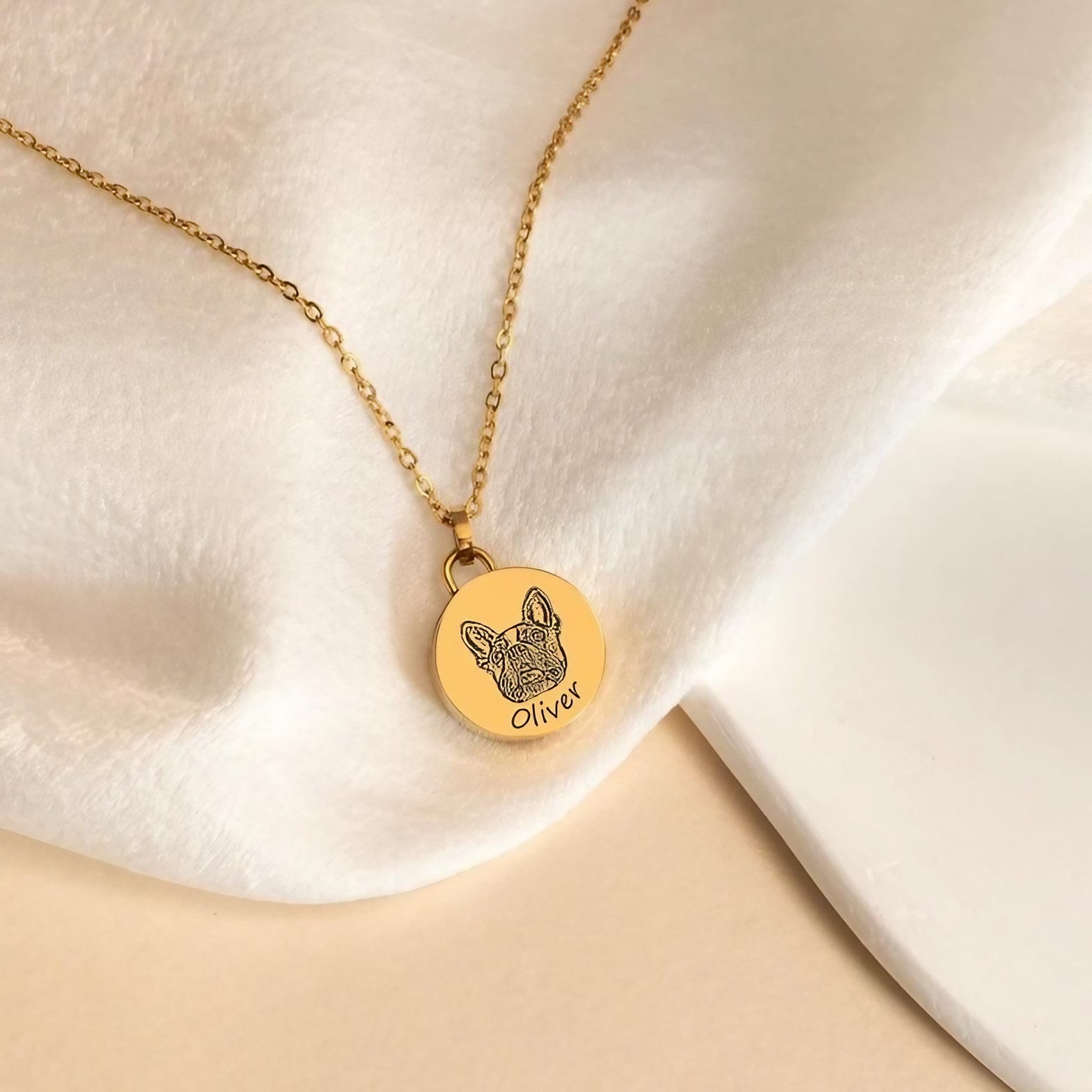 Detail of engraved pet name and portrait on a round memorial pendant necklace