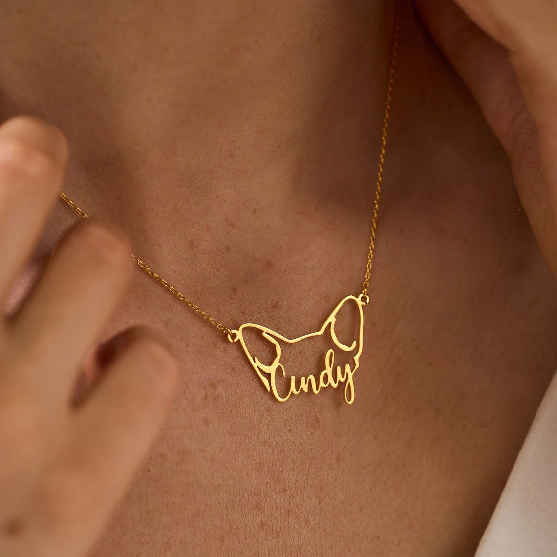 Person wearing a delicate personalized pet name necklace as a gift for pet moms
