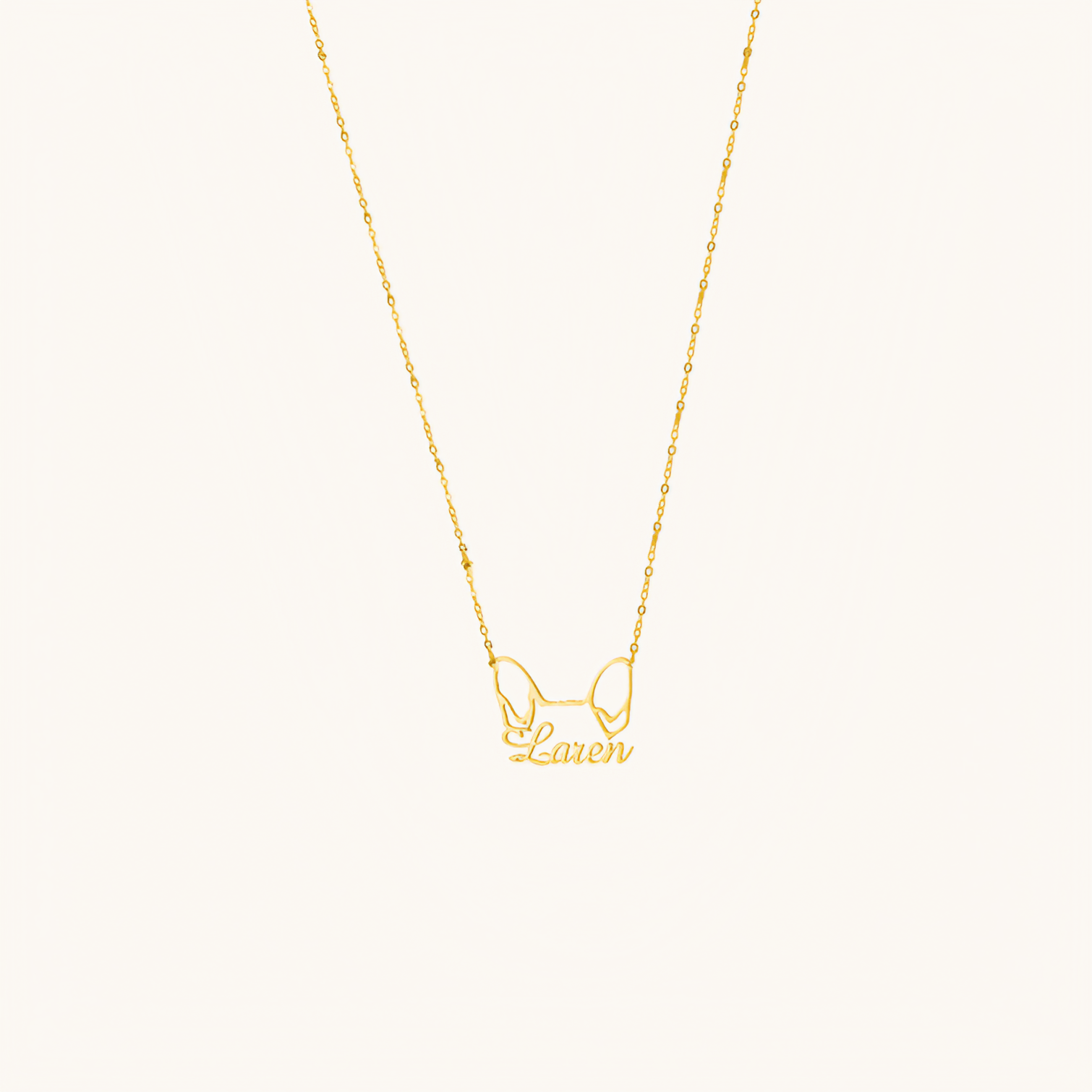 Custom pet name necklace with ear-shaped pendant engraved with pet name in gold finish