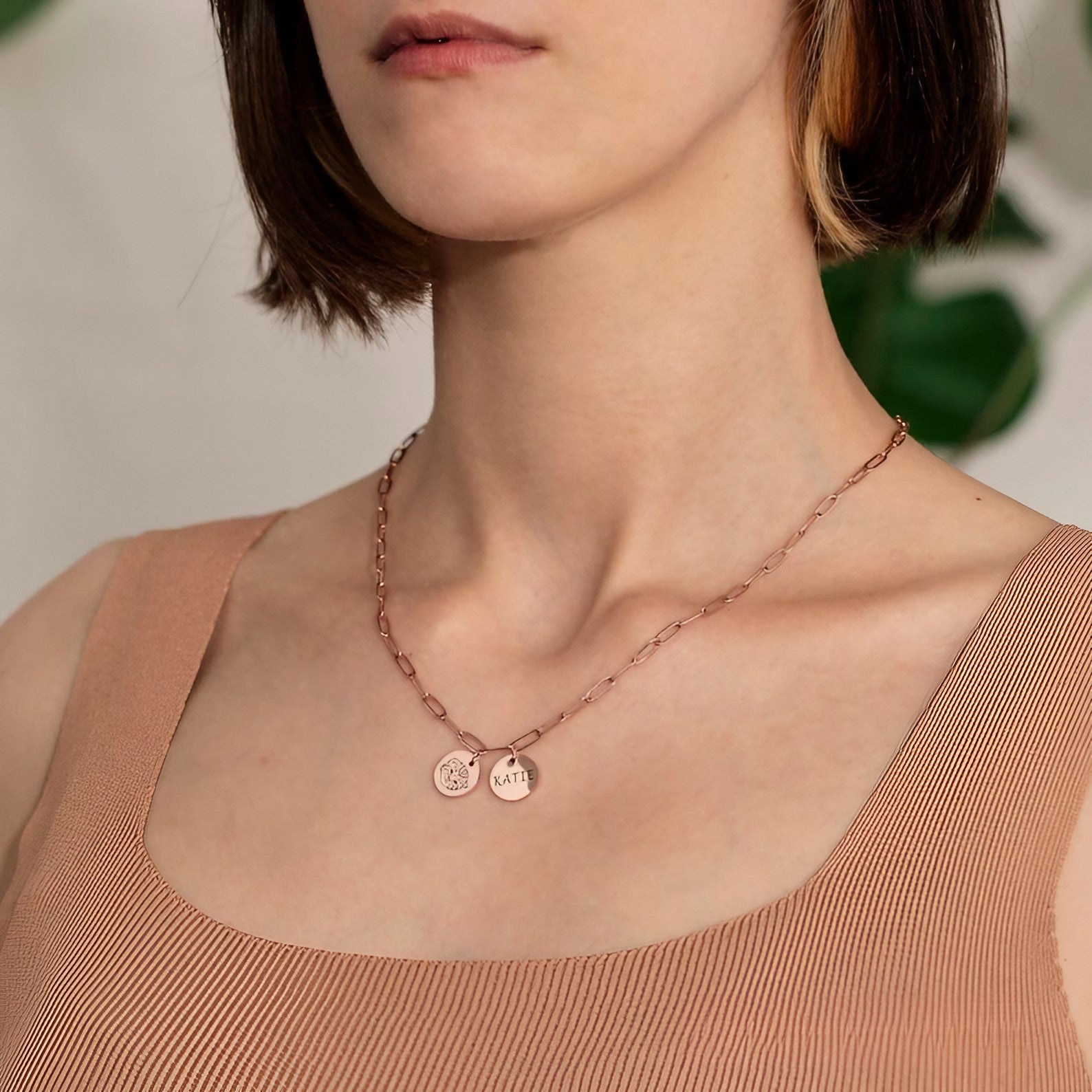 Person wearing a personalized pet photo charm necklace as a gift for dog moms