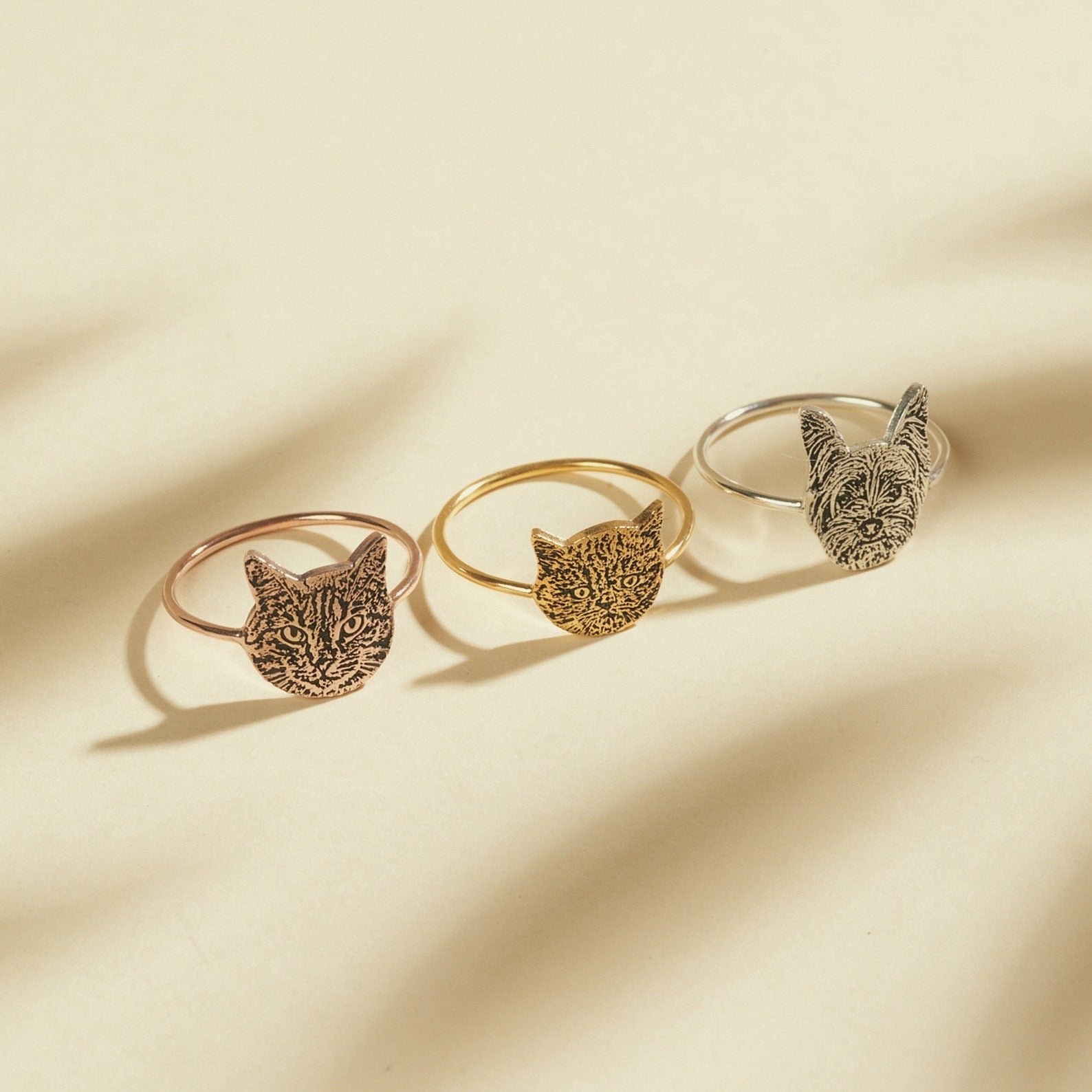 Custom pet portrait ring shown in gold, silver, and rose gold finishes side by side