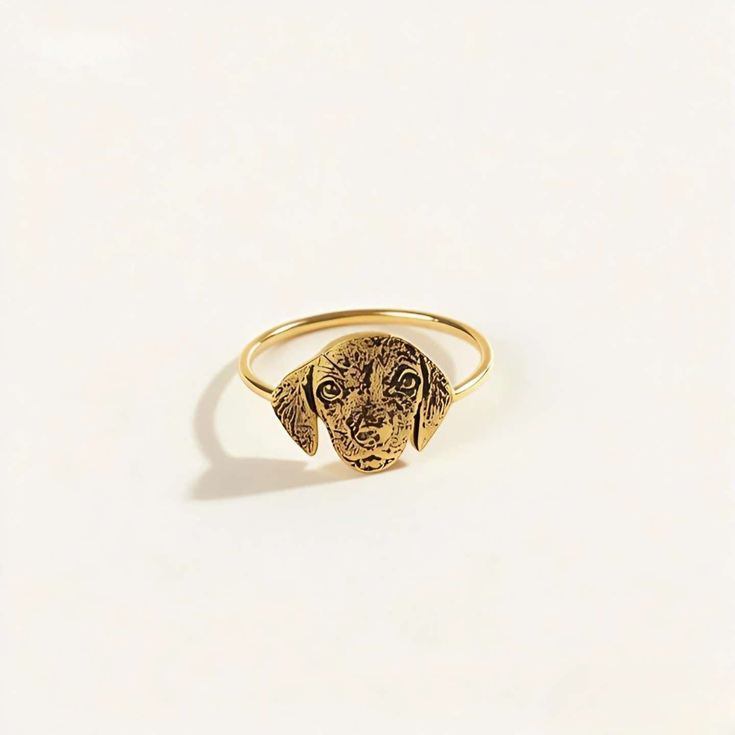 Custom pet portrait ring shaped like a pet head with engraved face detail in gold finish