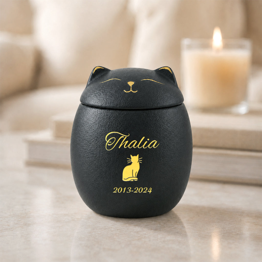 Cat keepsake cremation urn shown in black and white finish options side by side