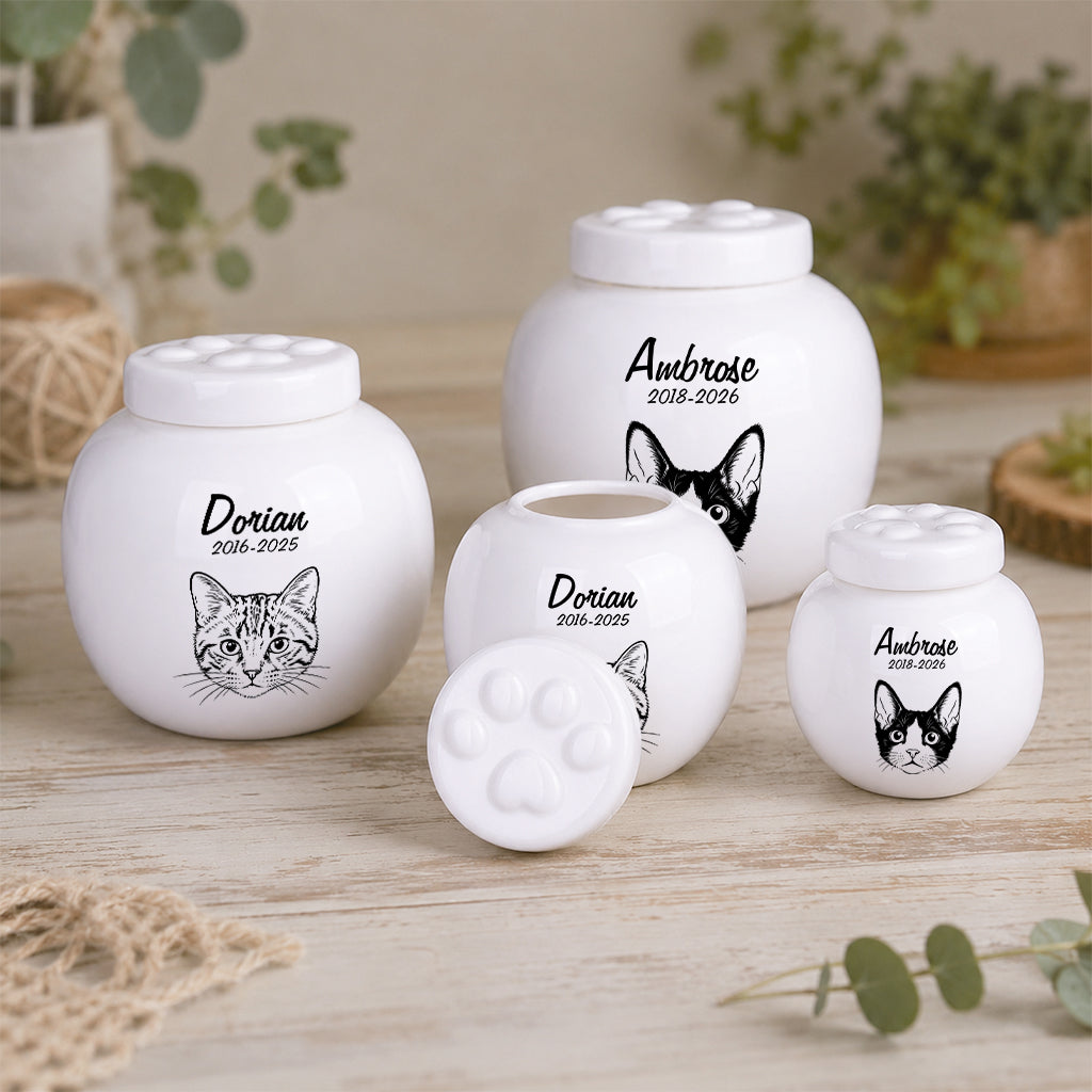Close-up of engraved cat name and memorial dates on a white ceramic cremation urn