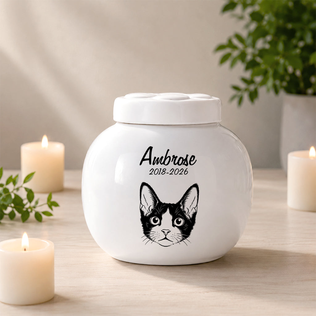 Cat memorial urn showing line art portrait style with name and remembrance years on the front