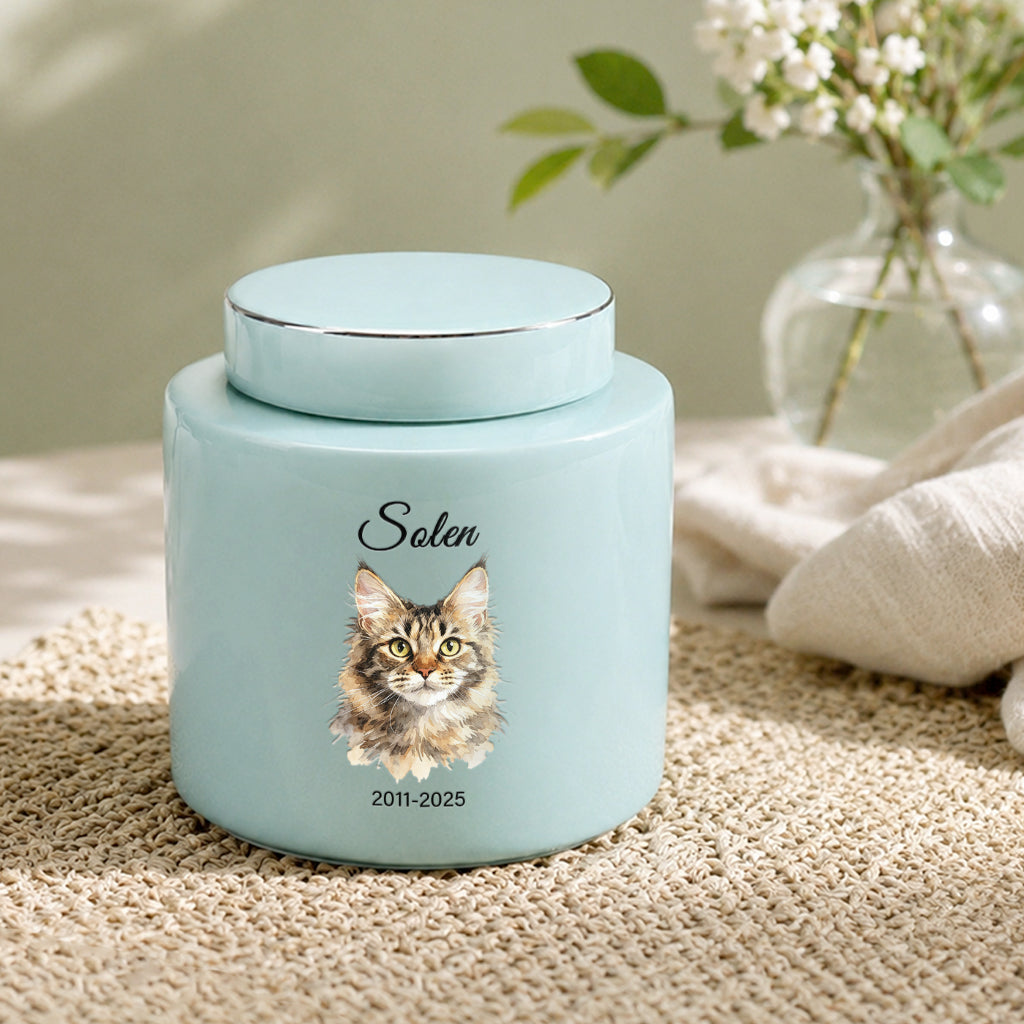 Side view of teal cat memorial urn showing smooth ceramic glaze and portrait placement