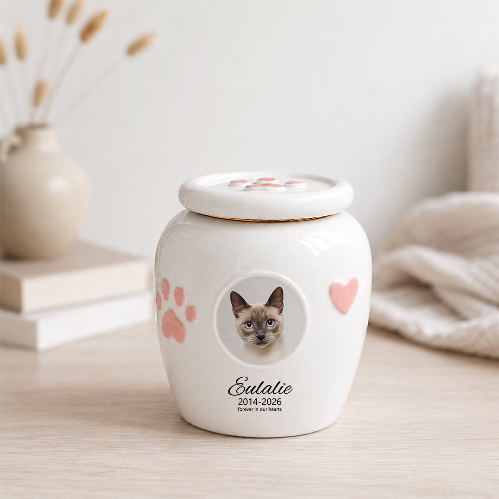 Close-up of circular photo window on a cat memorial urn showing custom cat portrait inside