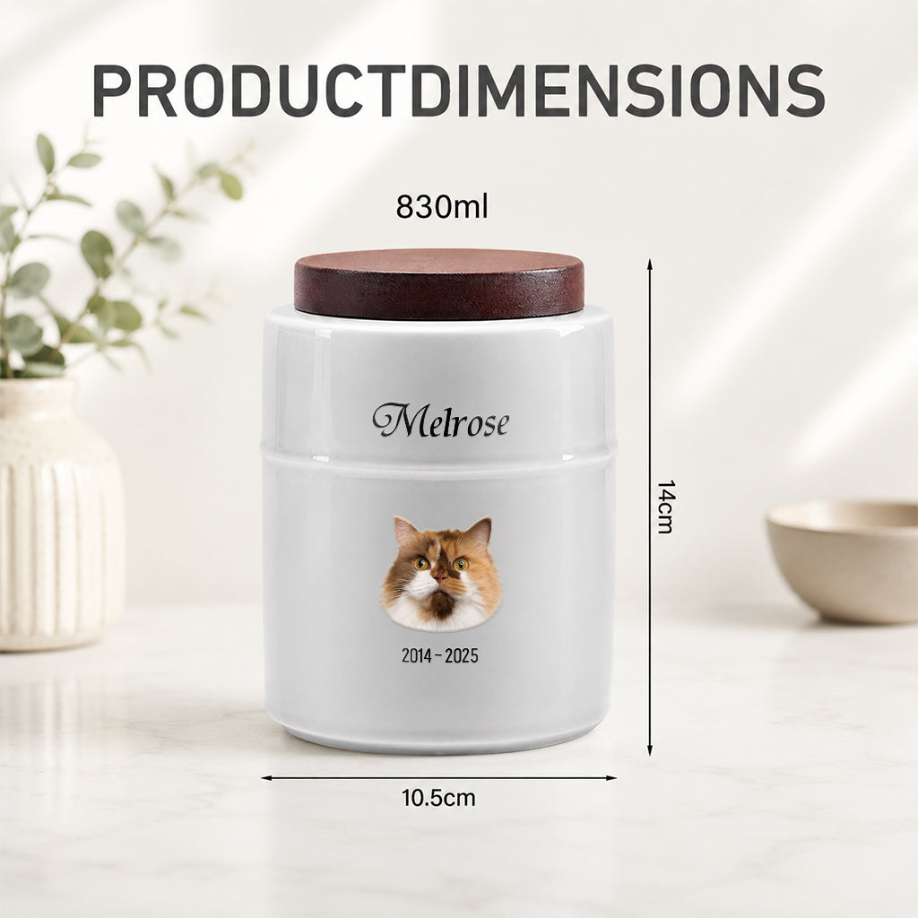 Close-up of custom cat portrait and name printed on a white ceramic cremation urn with wood lid