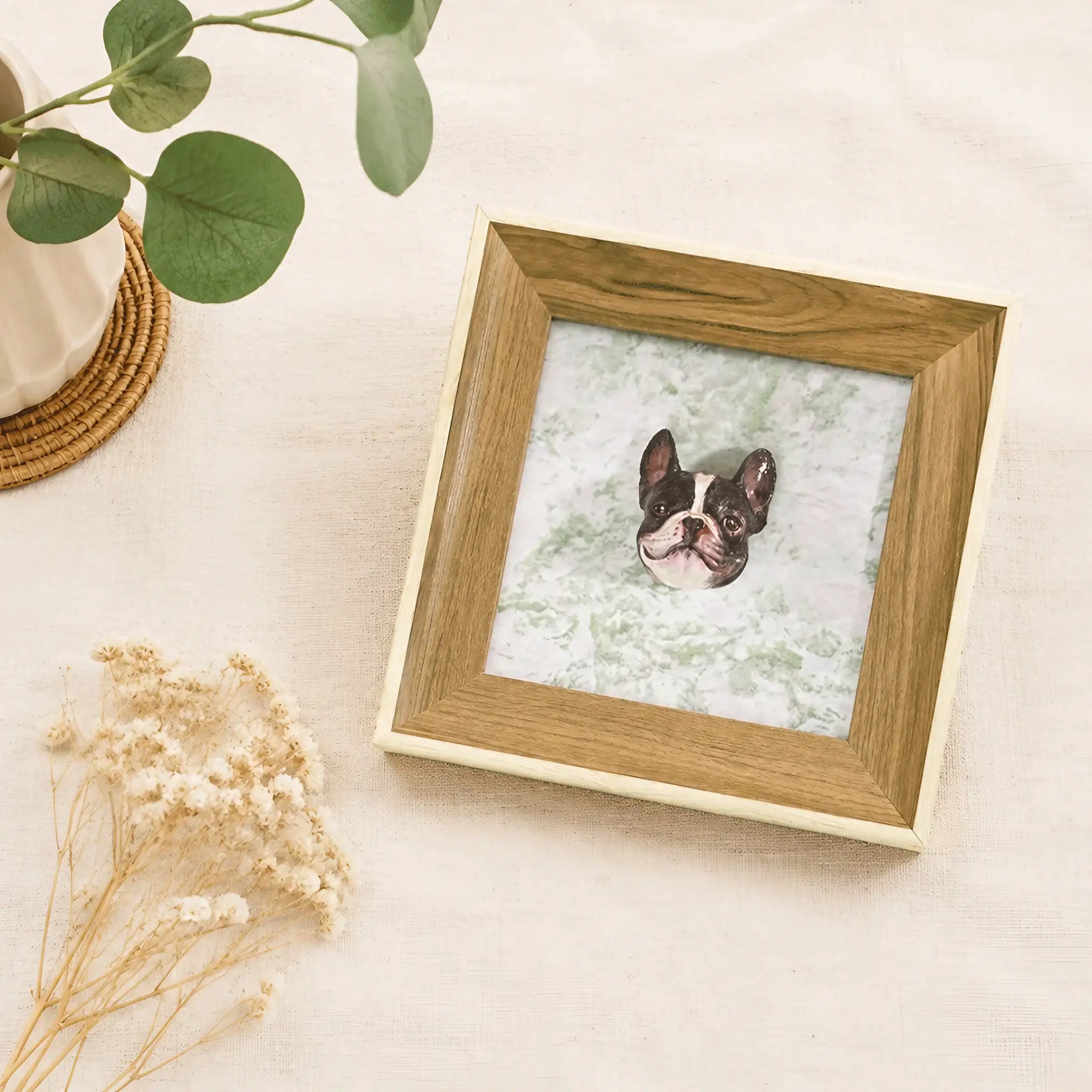 Custom 3D pet portrait frame laid flat on linen with eucalyptus and dried flowers