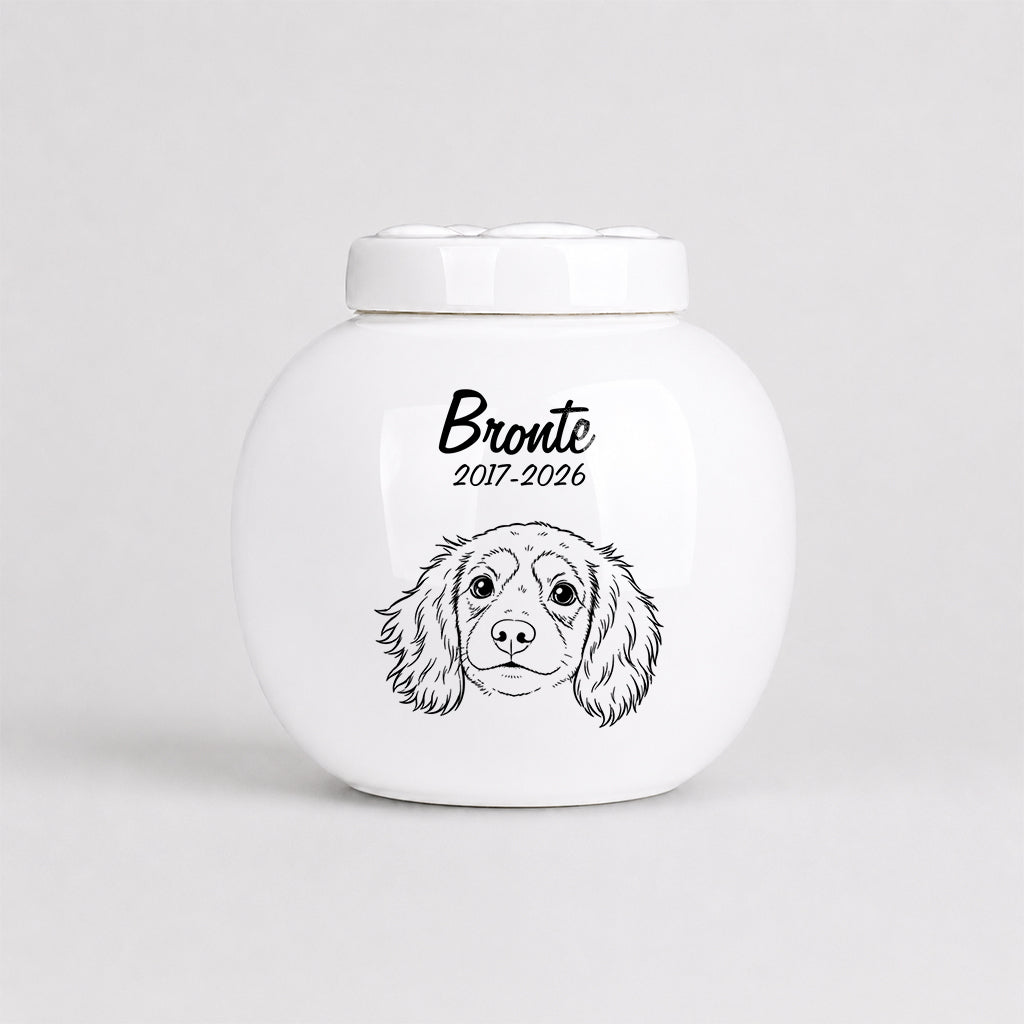 Personalized dog cremation urn shown from above with lid open displaying ceramic interior