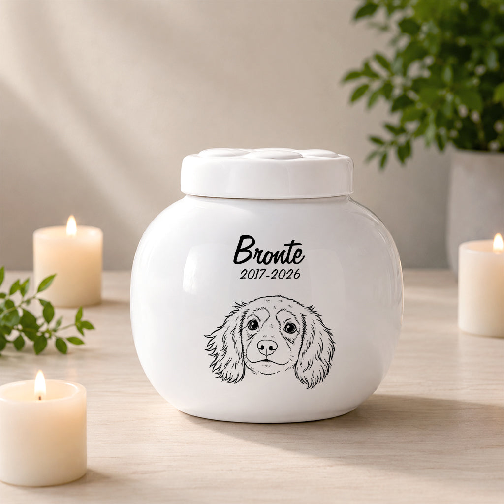 Side view of custom dog urn showing portrait illustration and smooth white ceramic finish