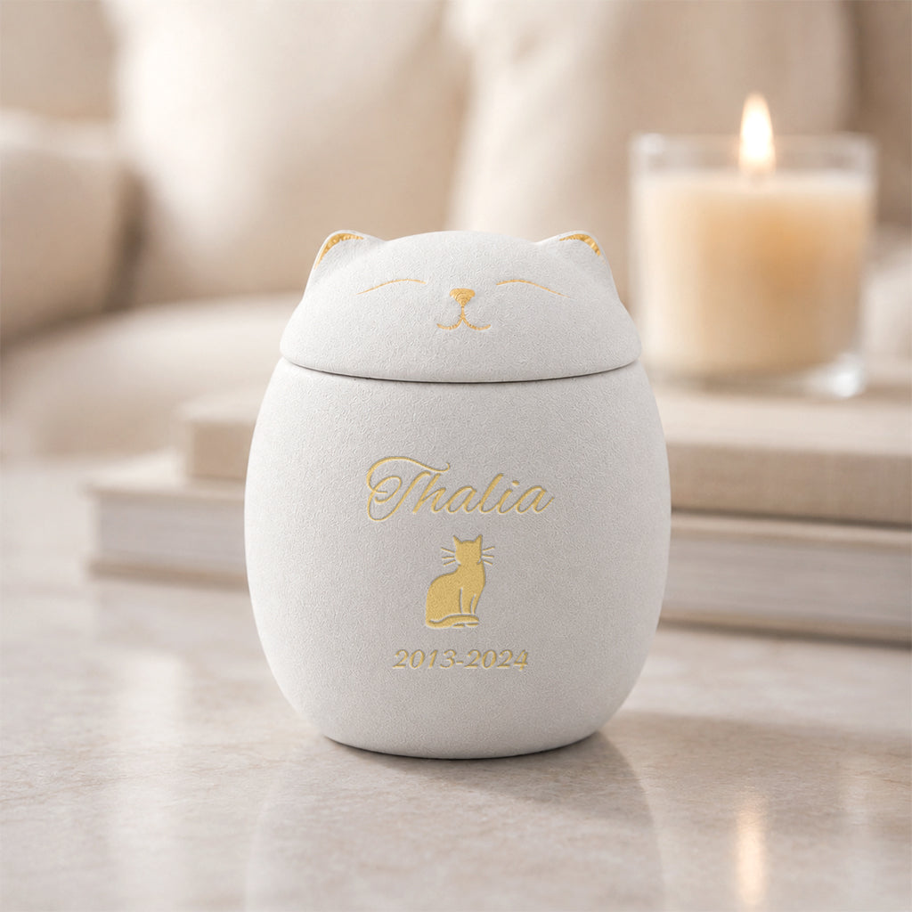 Side view of cat-shaped ceramic keepsake urn showing tail and paw sculpt detail