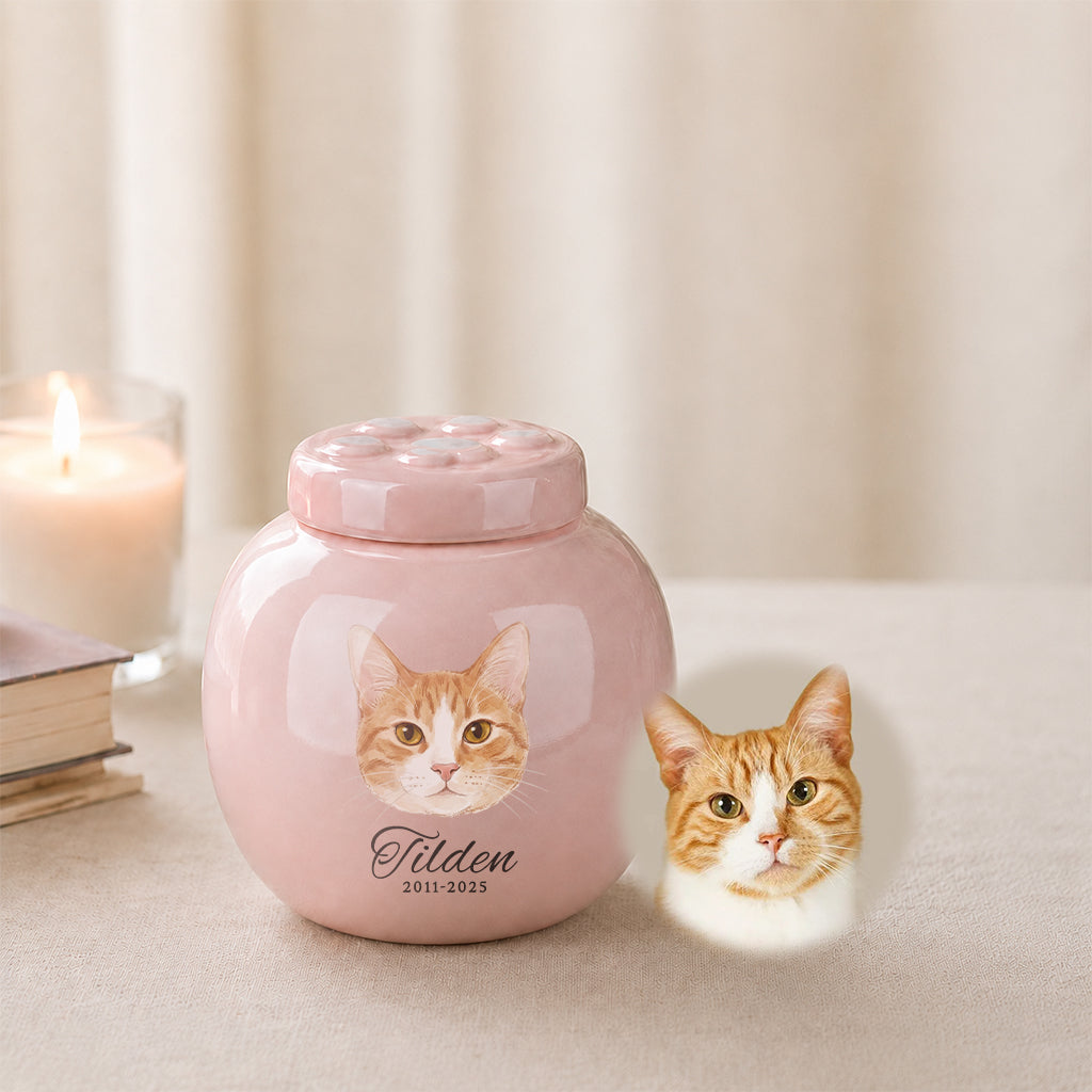 Side view of pink cat memorial urn showing paw print lid and smooth ceramic finish