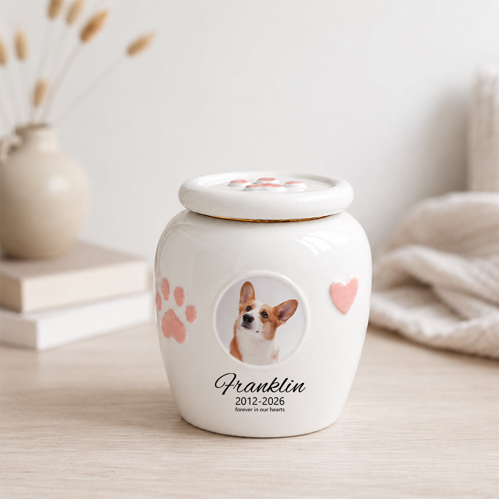 Close-up of circular photo window on a dog memorial urn showing custom dog portrait inside