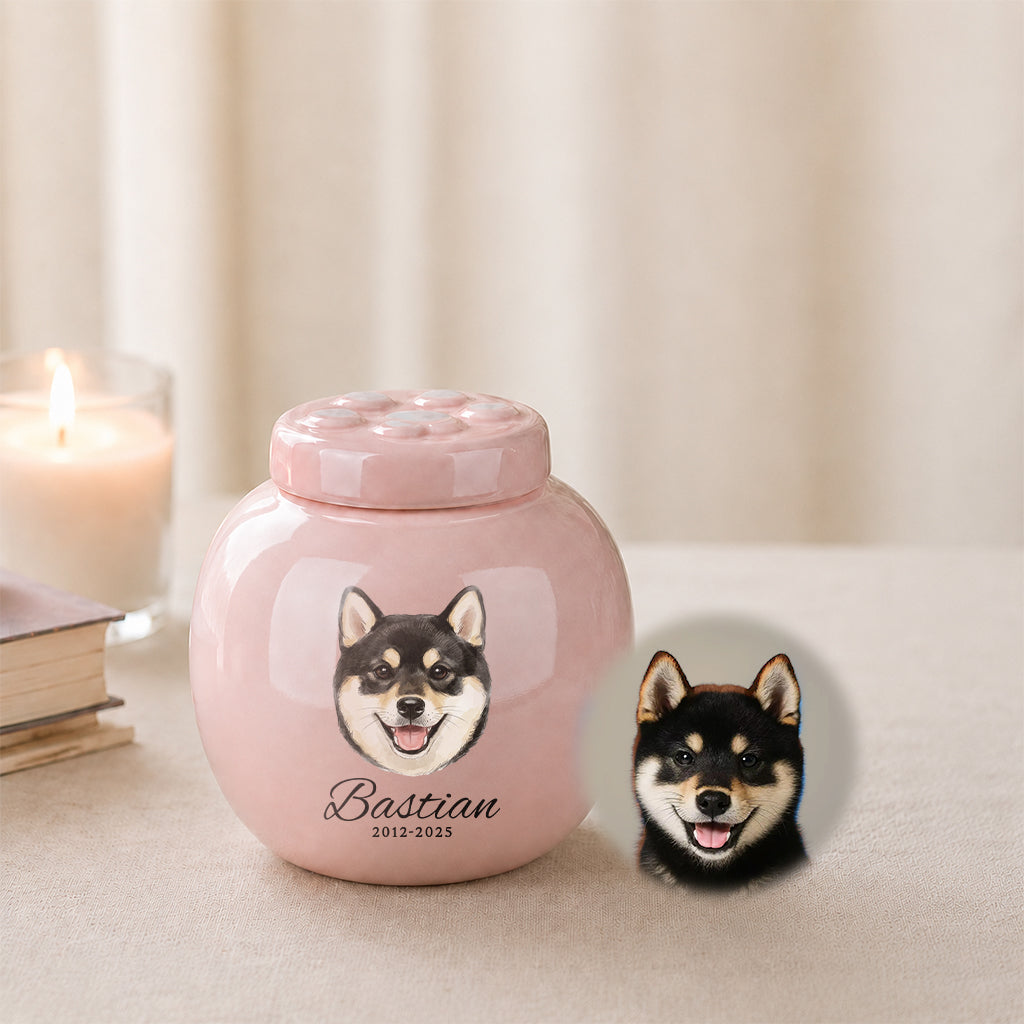 Side view of pink dog memorial urn showing paw print lid detail and smooth ceramic finish