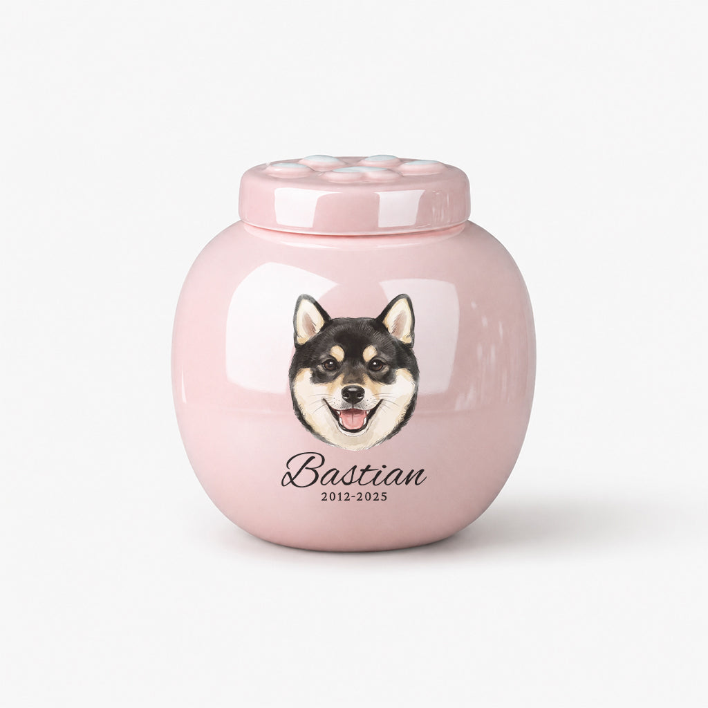 Top-down view of pink dog urn showing paw print lid design and ceramic texture
