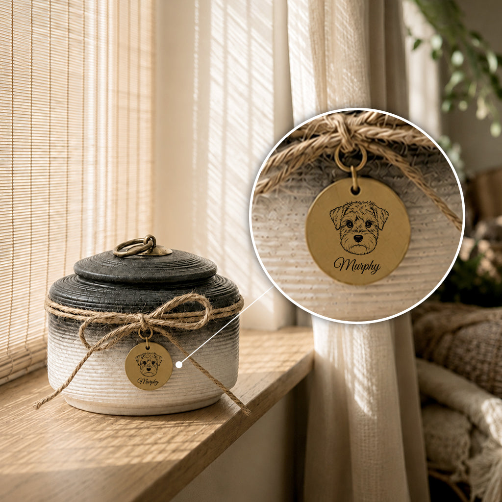 Dog cremation urn in ink black finish with hand-tied jute bow and personalized name charm
