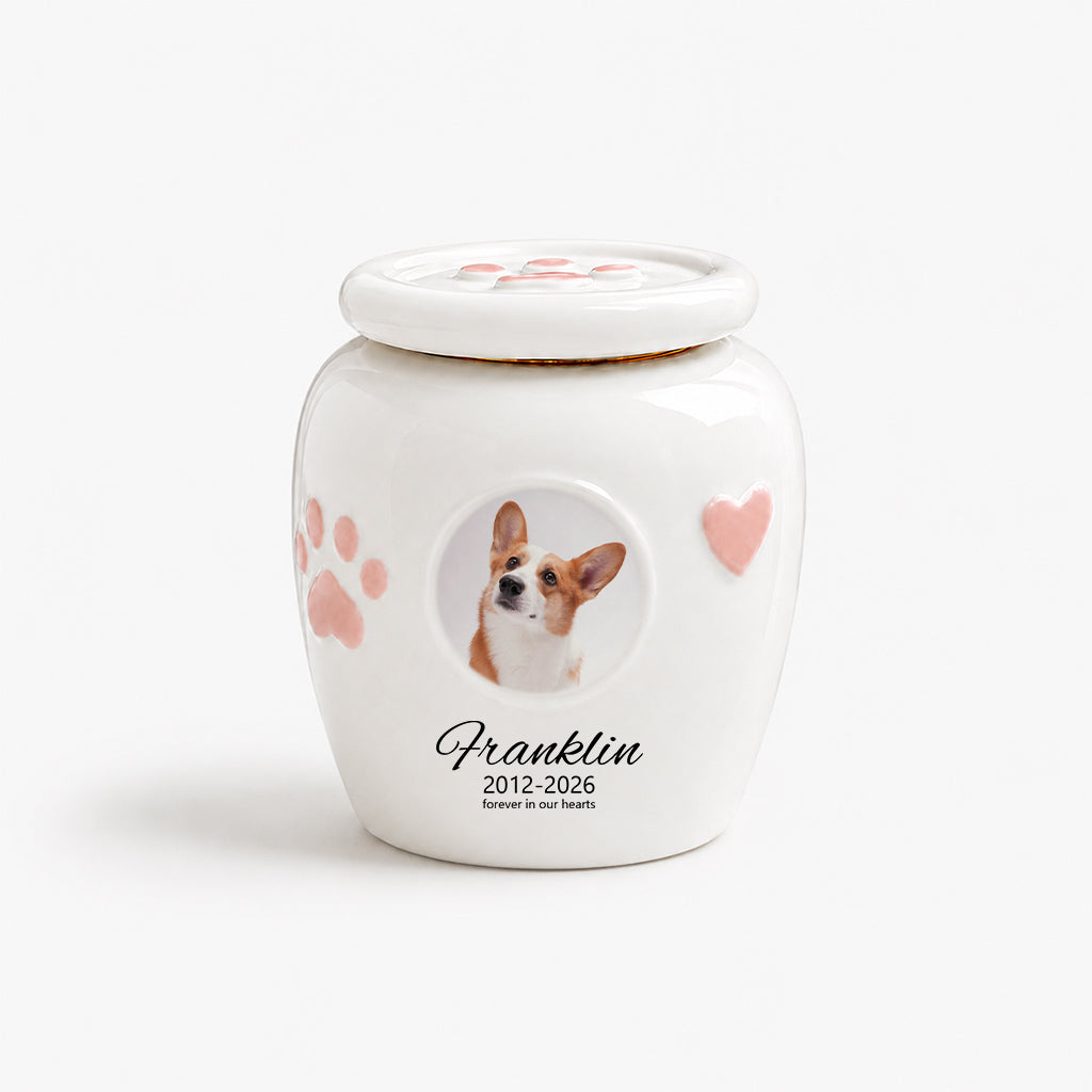Dog cremation urn with photo window shown in lifestyle setting on a wooden surface