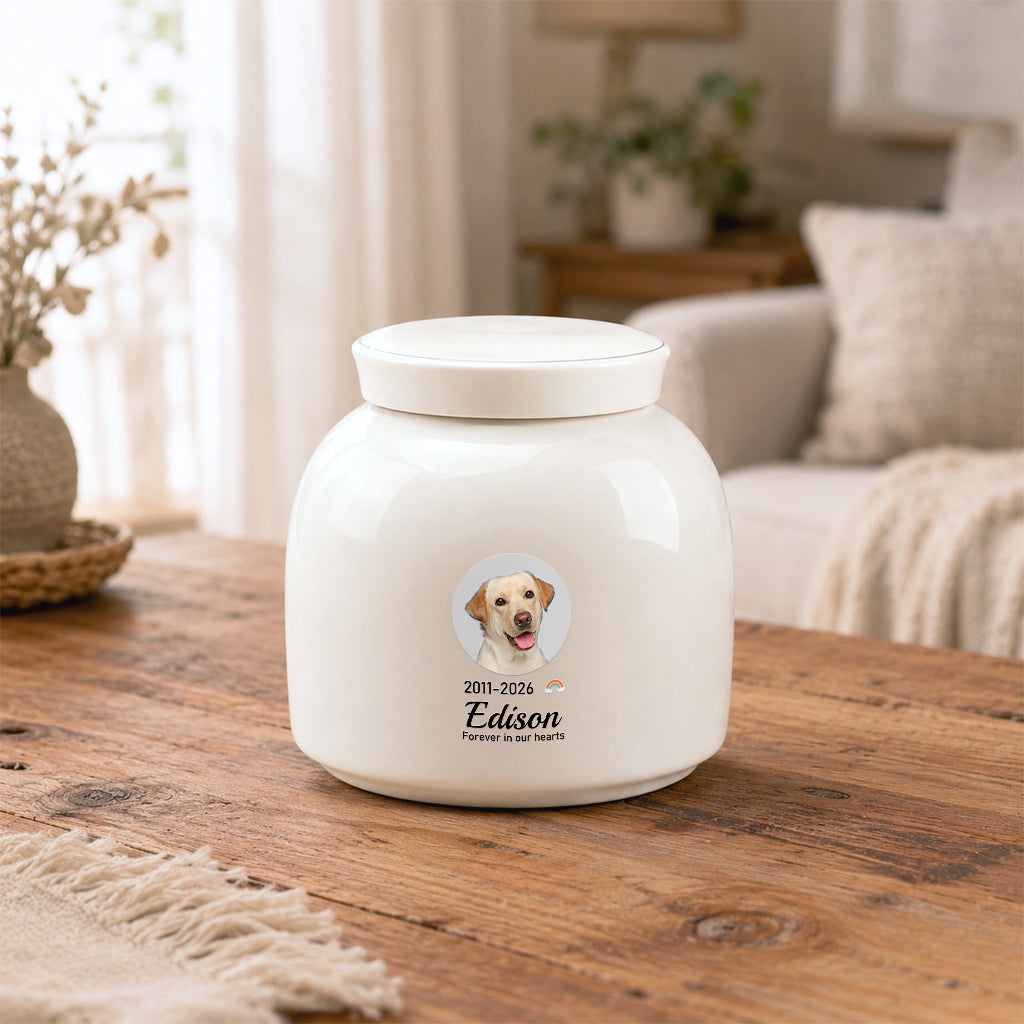 Close-up of circular dog photo, name, and dates printed on a round ceramic cremation urn