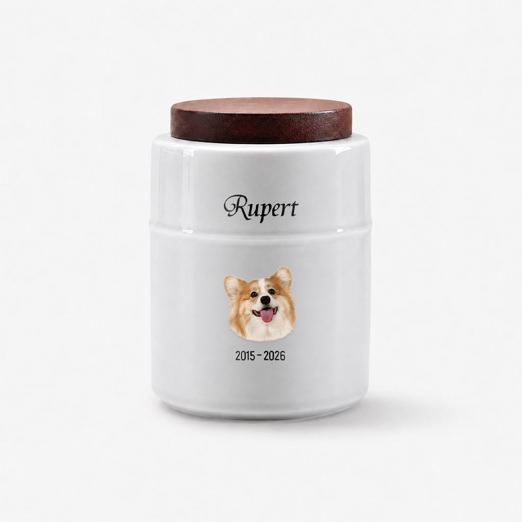 Personalized white dog cremation urn with wood lid displayed on a surface as a dog memorial keepsake