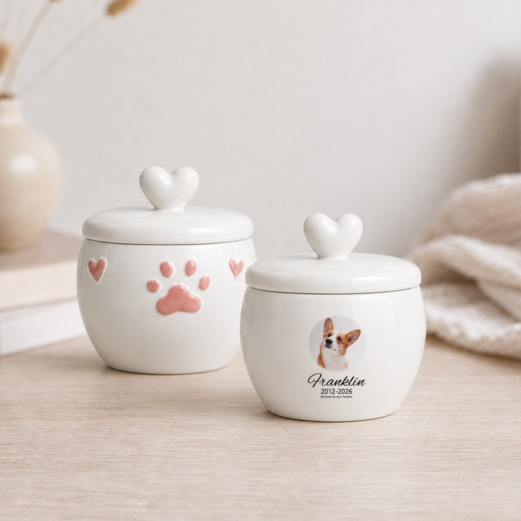 Side view of dog cremation urn with photo window showing smooth white ceramic and paw print detail