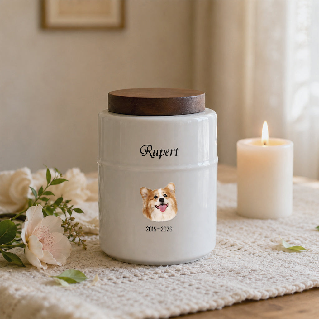 Side view of white cylindrical dog memorial urn showing wood lid and smooth ceramic body