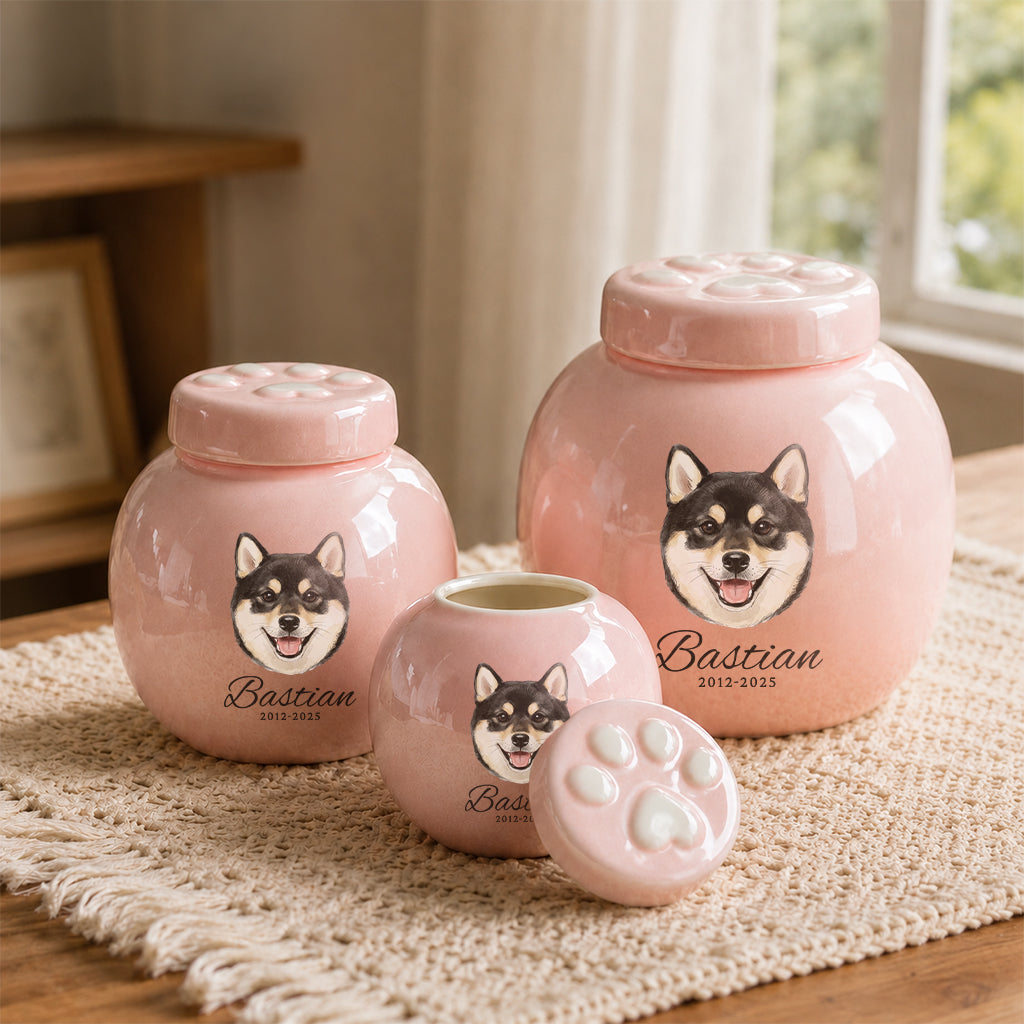 Close-up of custom dog portrait and engraved name printed on a pink ceramic cremation urn