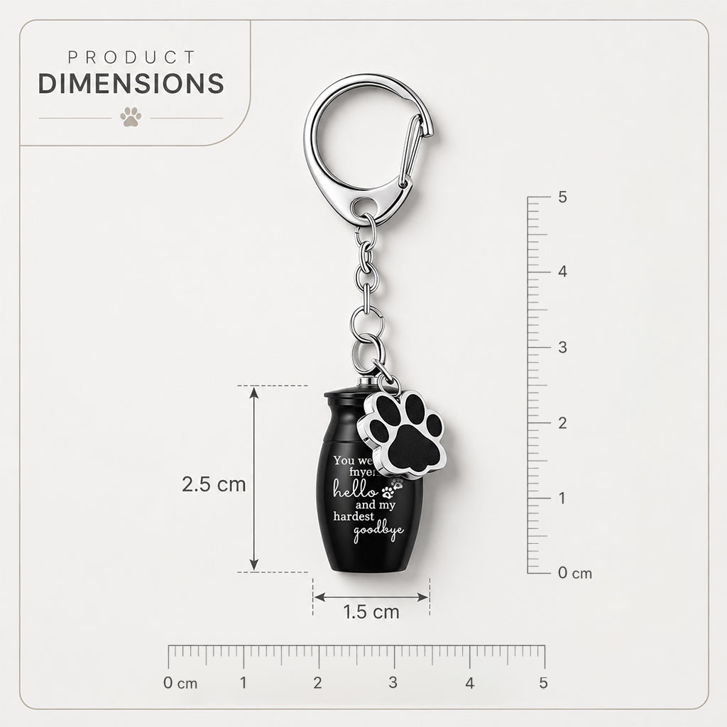Mini pet memorial urn keychain held in a hand showing its compact size and screw-top seal