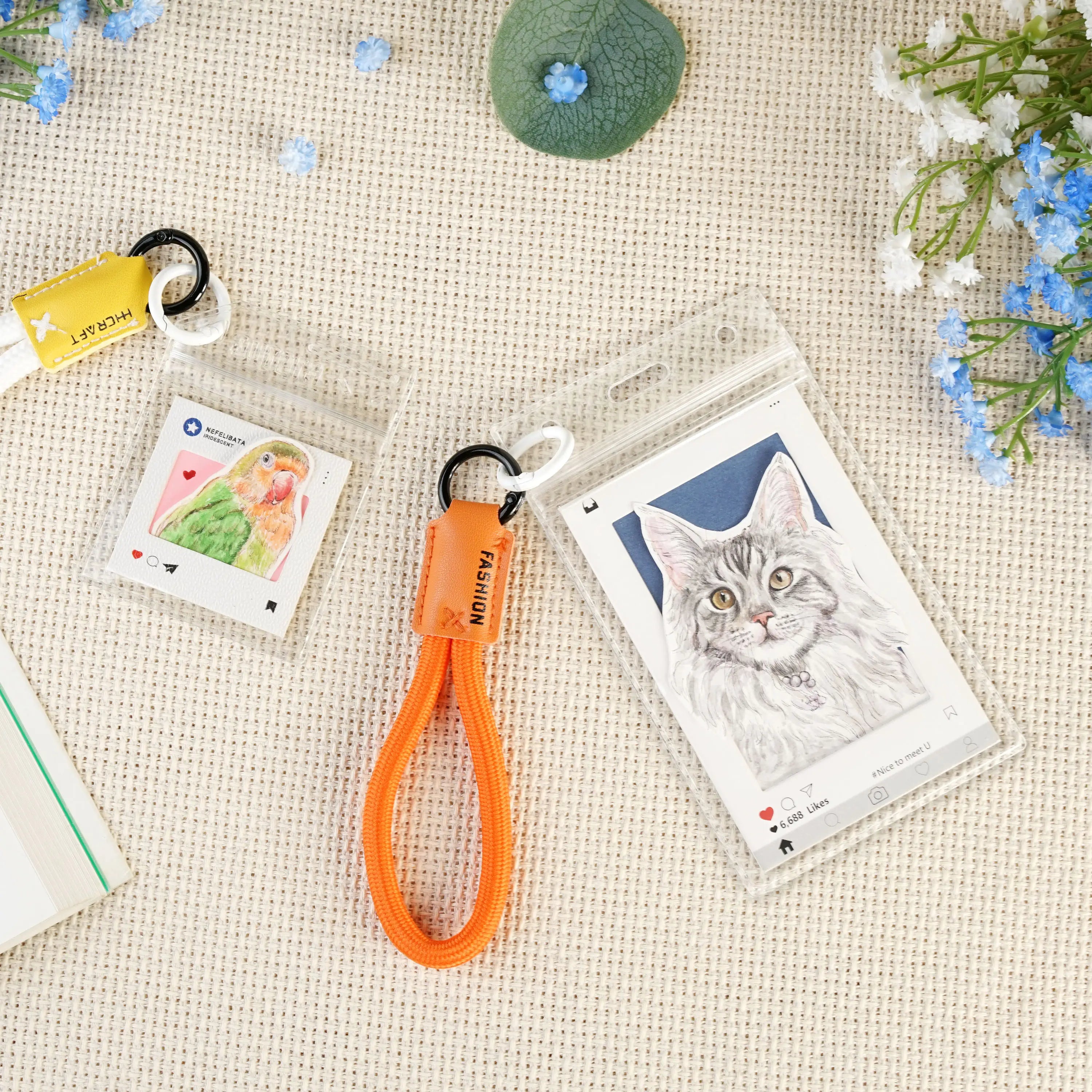 Custom pet portrait keychains including a cat and a parrot in hand-painted watercolor