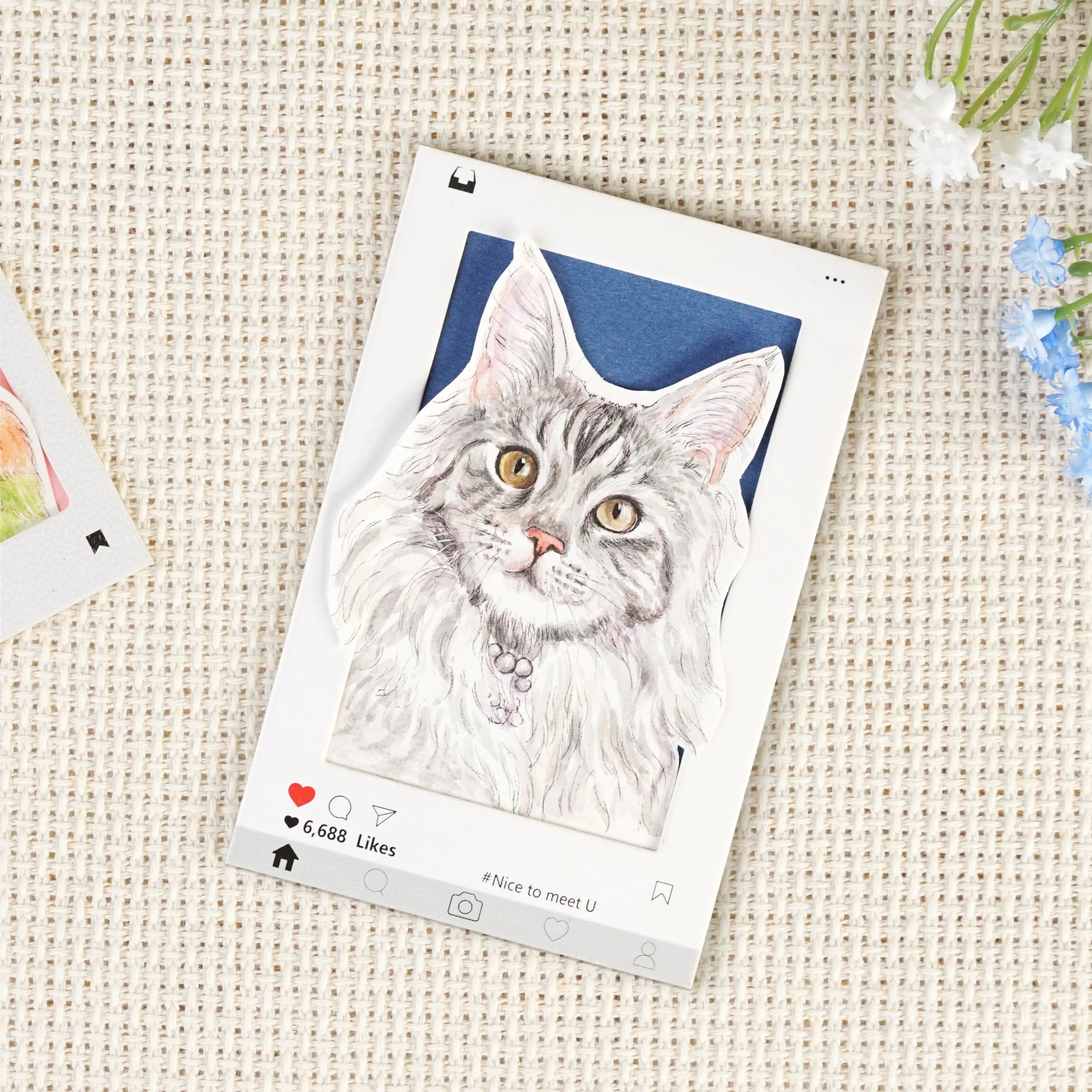 Custom cat portrait keychain card flatlay showing the hand-painted watercolor Instagram-style frame