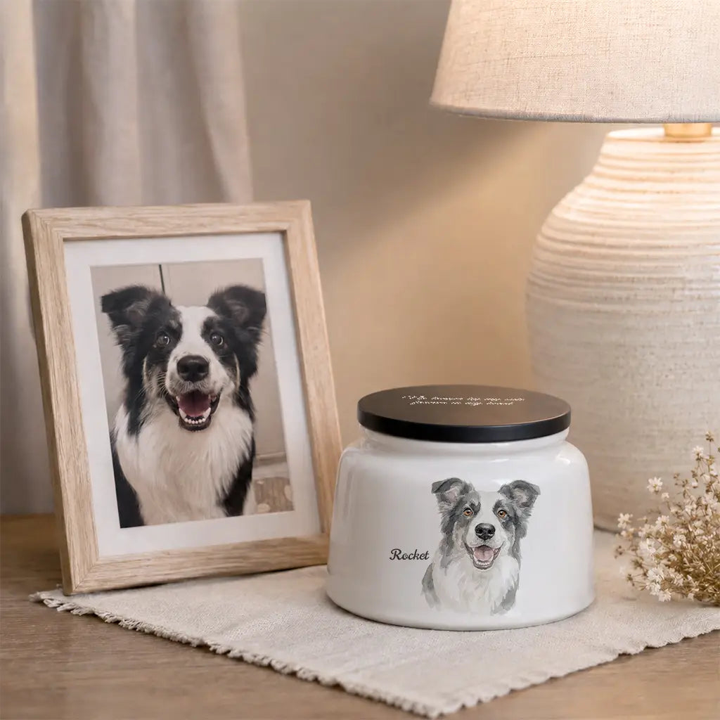Close-up of the watercolor dog portrait and name on a personalized white ceramic cremation urn