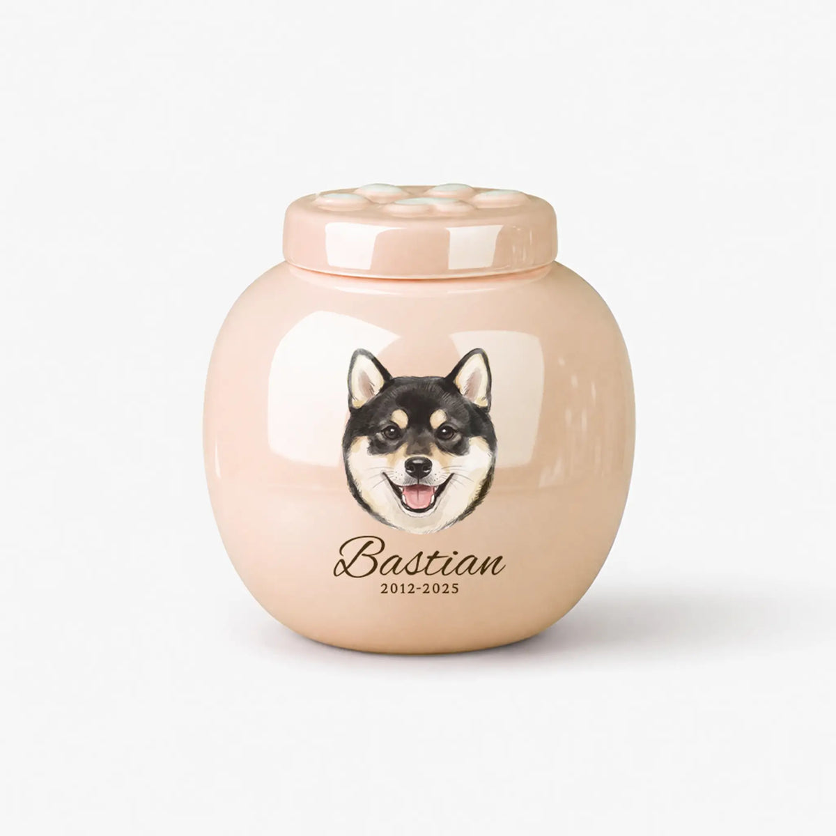 Pink personalized dog cremation urn with a watercolor pet portrait, engraved name, and paw‑print lid on a plain white background.