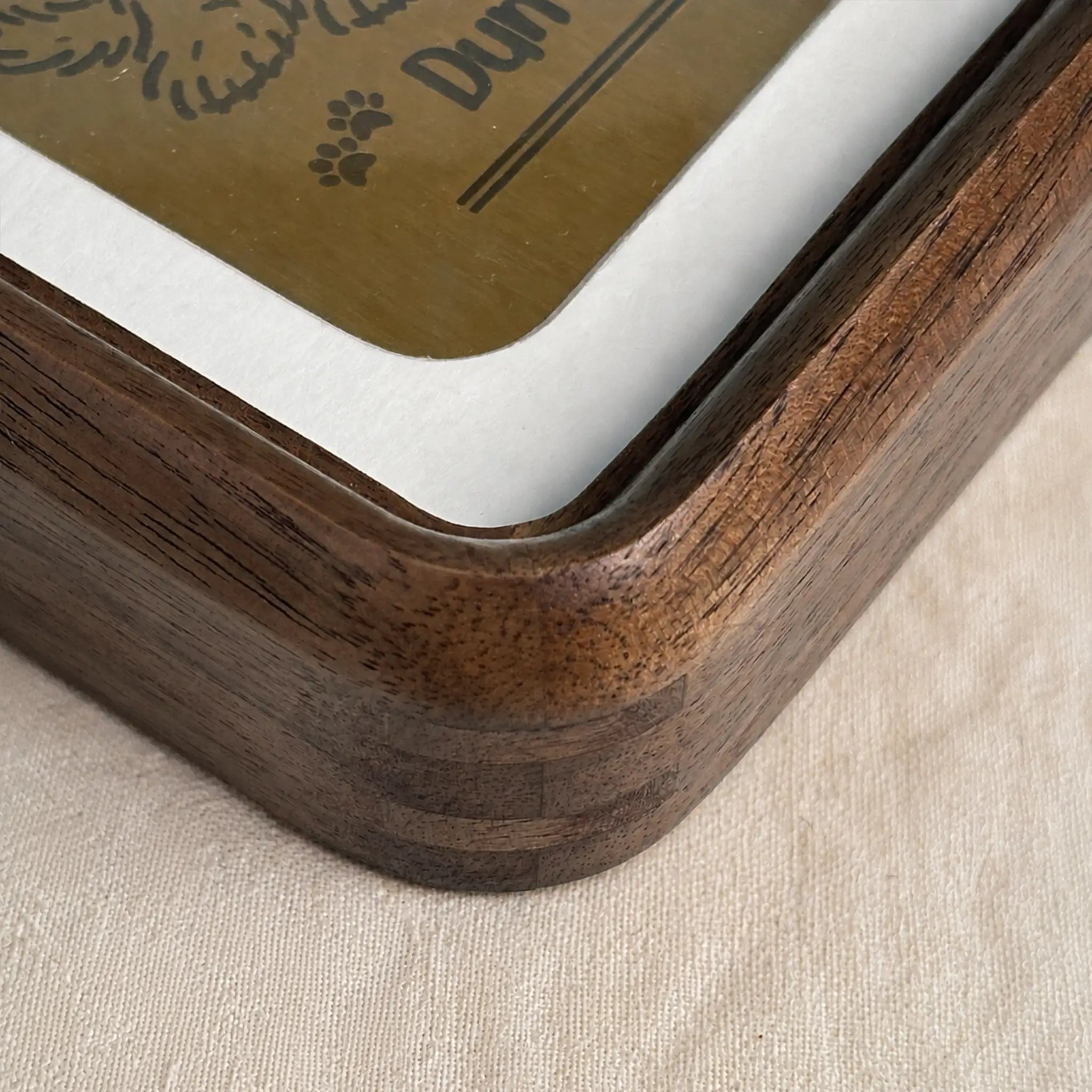 Close-up of the solid walnut wood frame showing rounded corners and natural grain